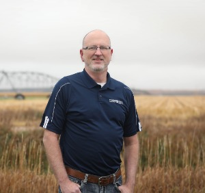 Monty Schriver standing by corn field