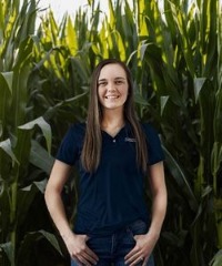 Loan officer, Hannah Jakubowski standing in cornfield