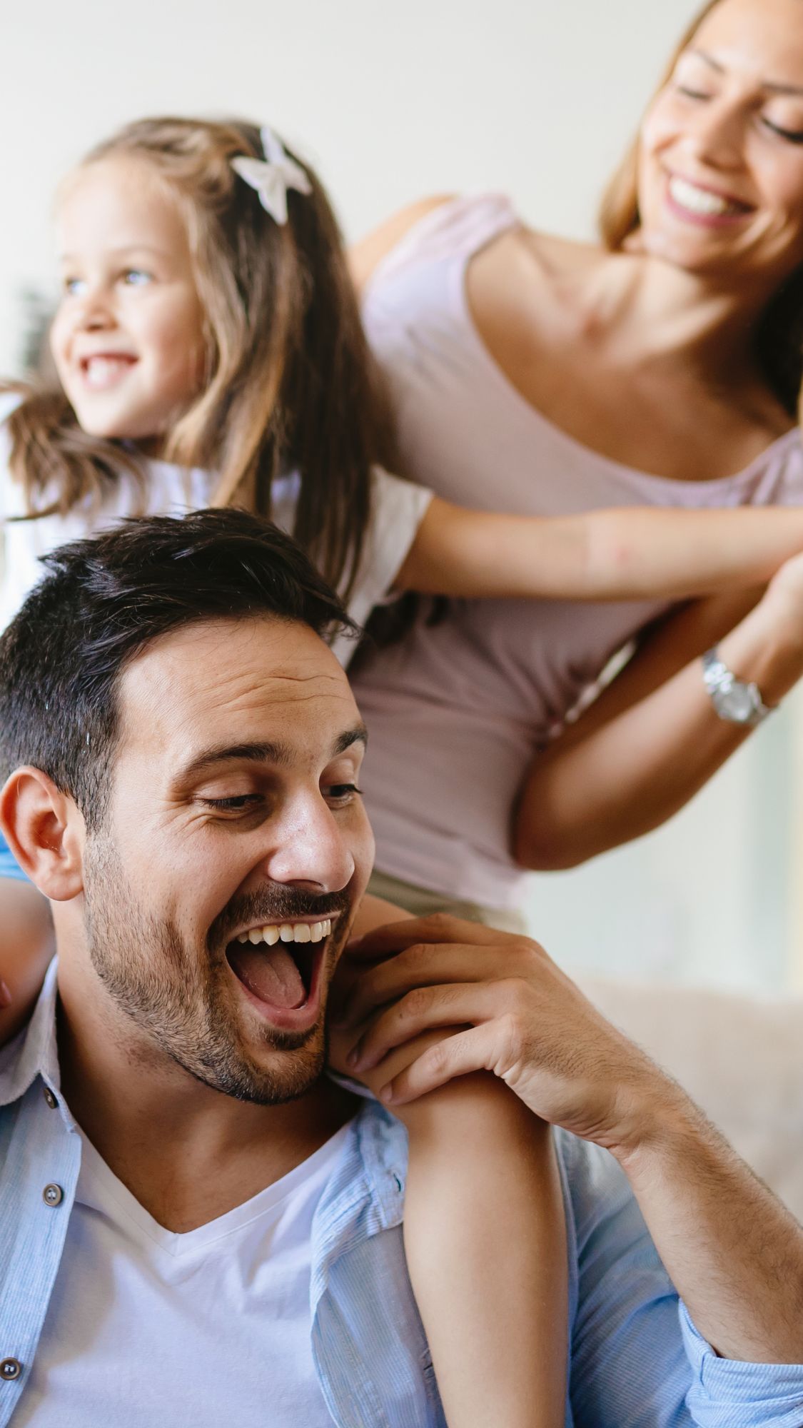young family of three smiling