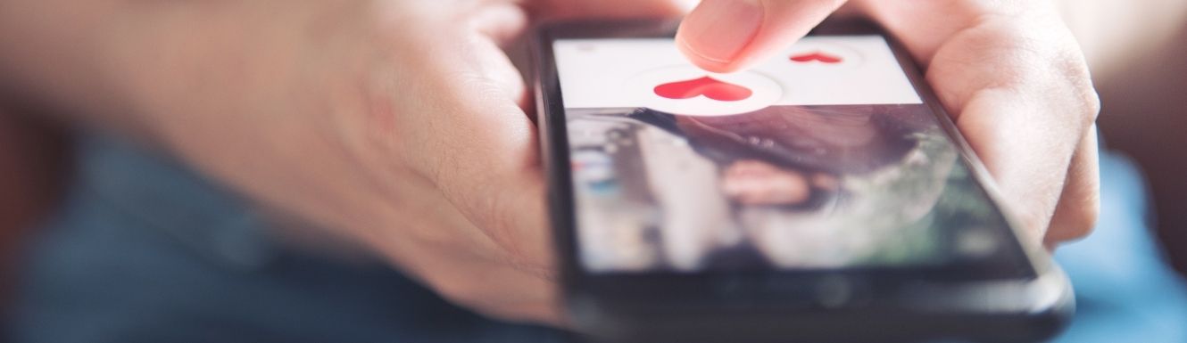 Close up image of person on phone using a dating app