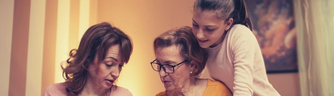 mom, daughter, and grand daughter looking at an image