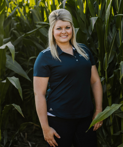 Morgan Fornoff, Assistant Vice President standing in front of corn stalks