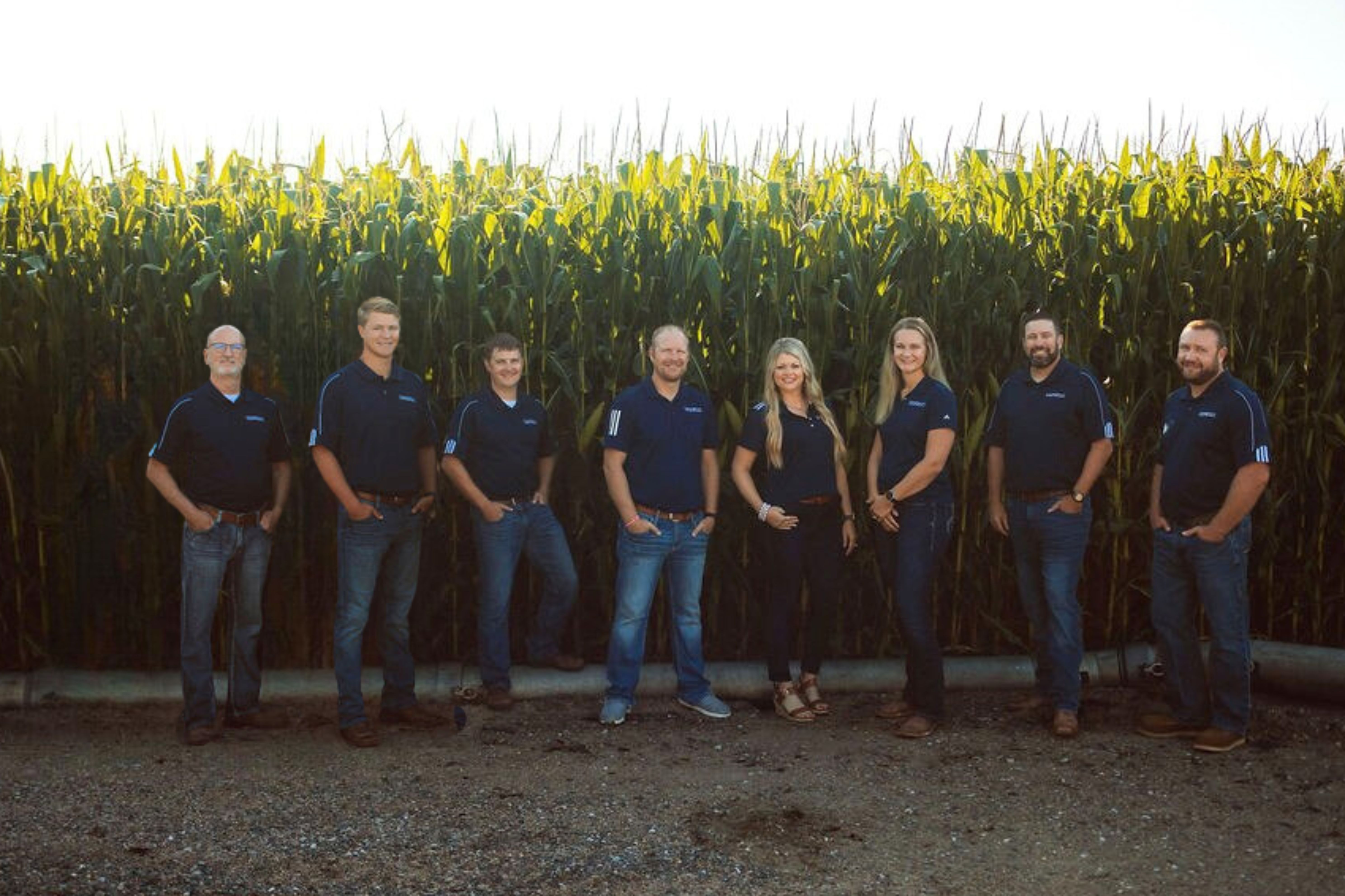 Picture of our loan officer team in front of a corn field