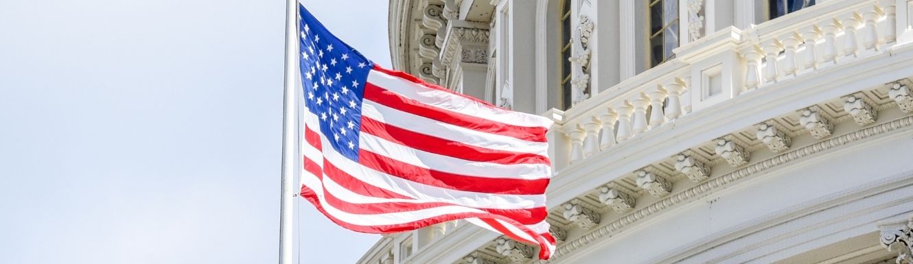 U.S. Flag waving in wind in front of U.S. capitol