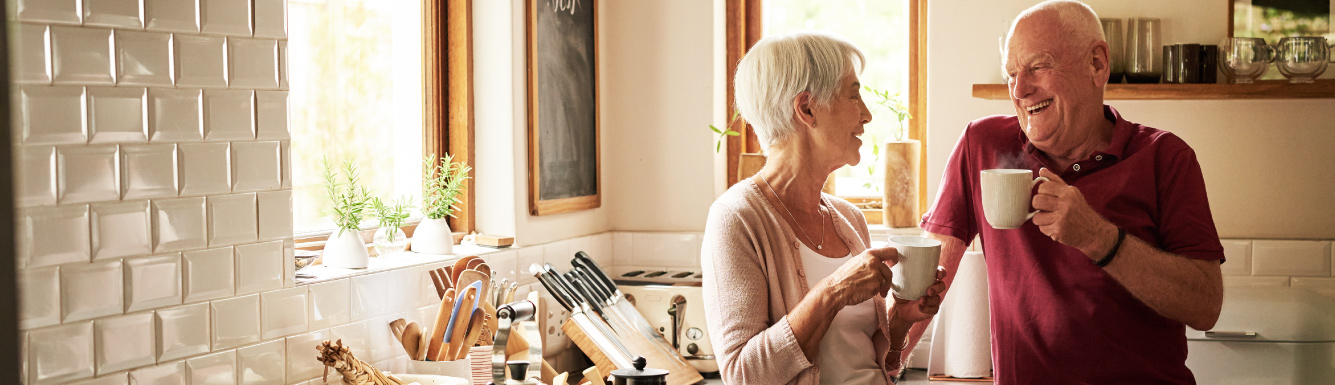 Mature couple in kitchen with coffee