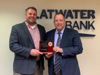 Flatwater Bank President, Luke Rickertsen presenting plaque to Nathan Wyatt