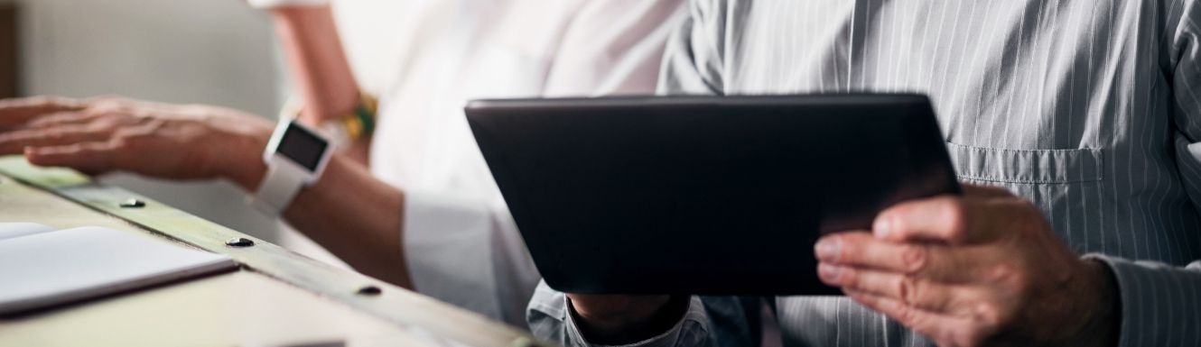 Close up image of man using a tablet.