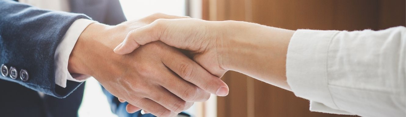 Zoomed-in photo of man and women shaking hands