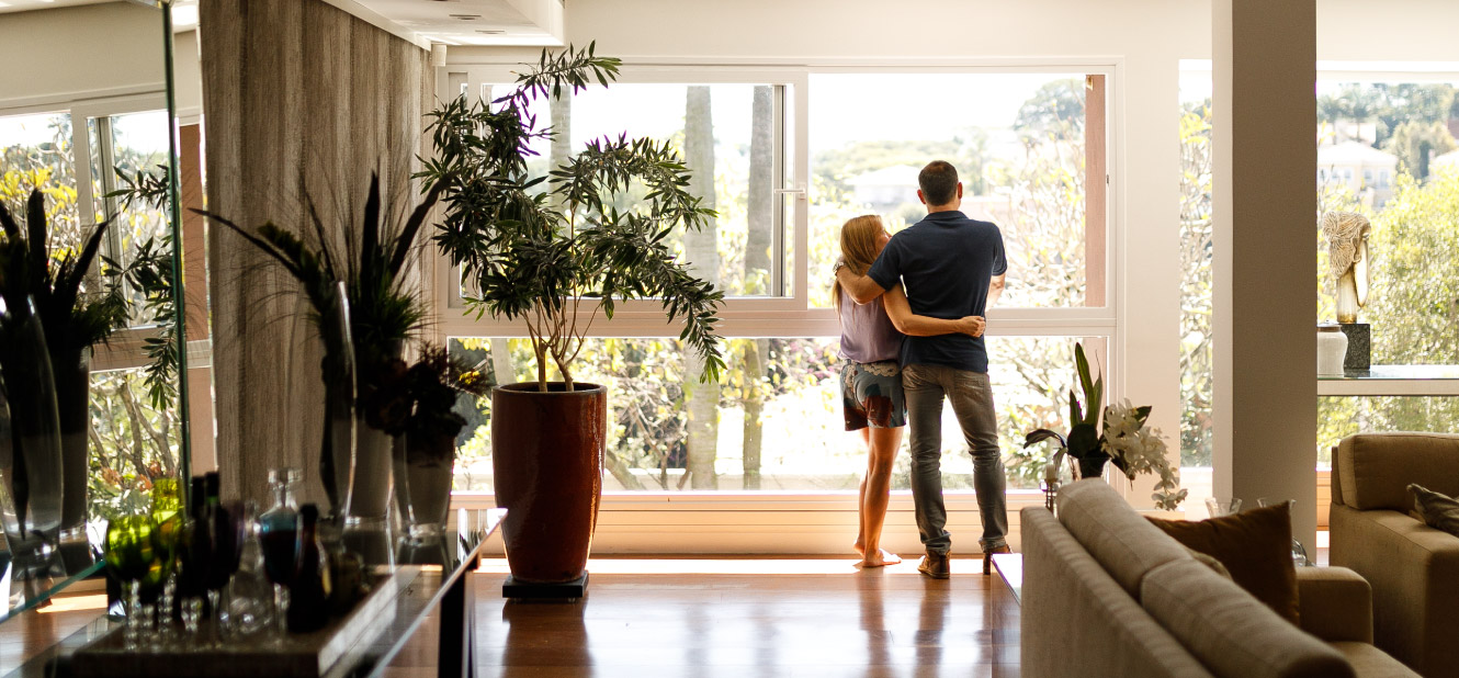 Couple standing in window in home